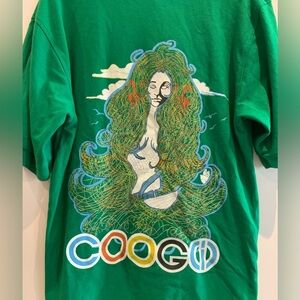 Men’s Green Coogi brand polo shirt with artistic graphic on the back